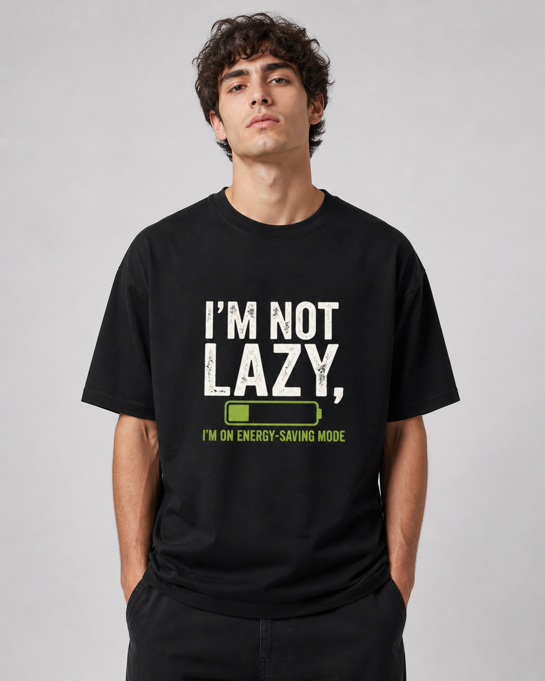 Person wearing a black t-shirt with 'I'm not lazy, I'm on energy-saving mode' text.